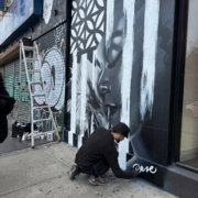 Dase painting a mural in Manhattan. Photo by Sarah Sansom.