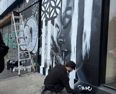 Dase painting a mural in Manhattan. Photo by Sarah Sansom.